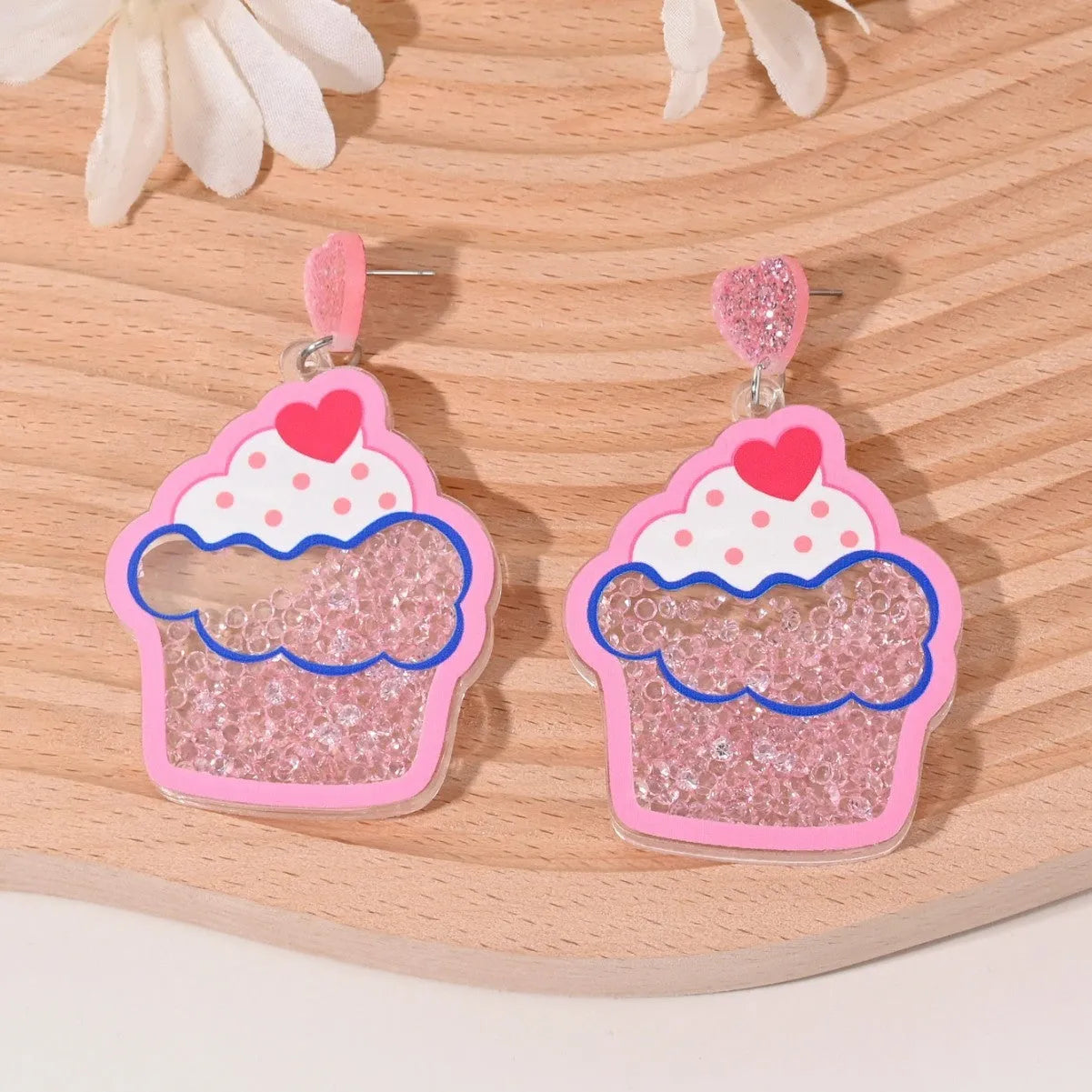 Colourful acrylic earrings with fruit and dessert designs including cherry, strawberry and watermelon shapes