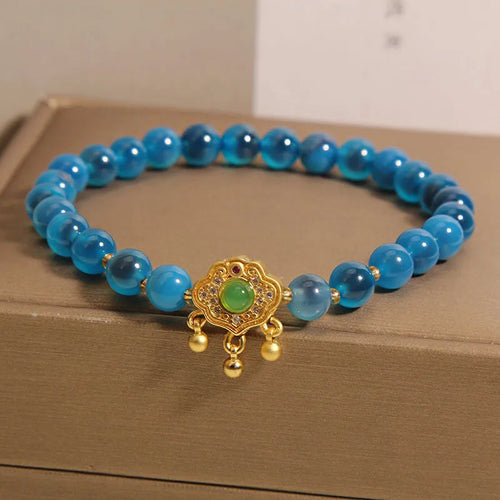 Blue sugar heart agate safety lock pendant on a crystal women's bracelet with alloy-set stones.