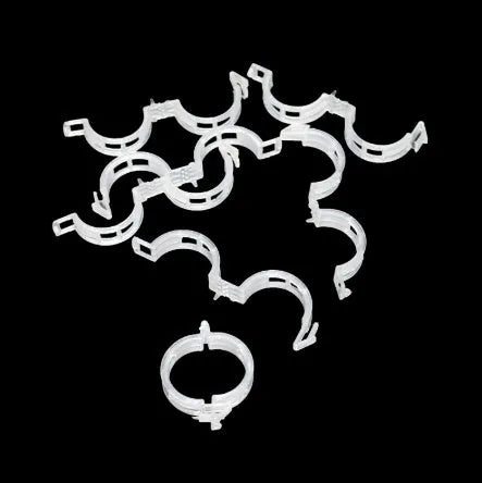 Assortment of 50 smooth plastic plant grafting clips for garden use on a white background.
