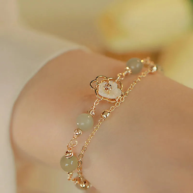 Women's yellow gold butterfly bracelet made from electroplated copper with a geometric shape.