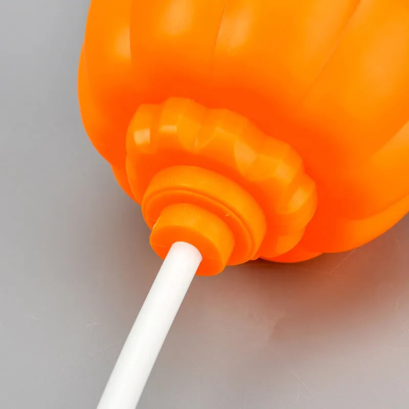 Plastic pumpkin-shaped USB lamp emitting yellow or purple light, 8.3cm wide by 22cm tall