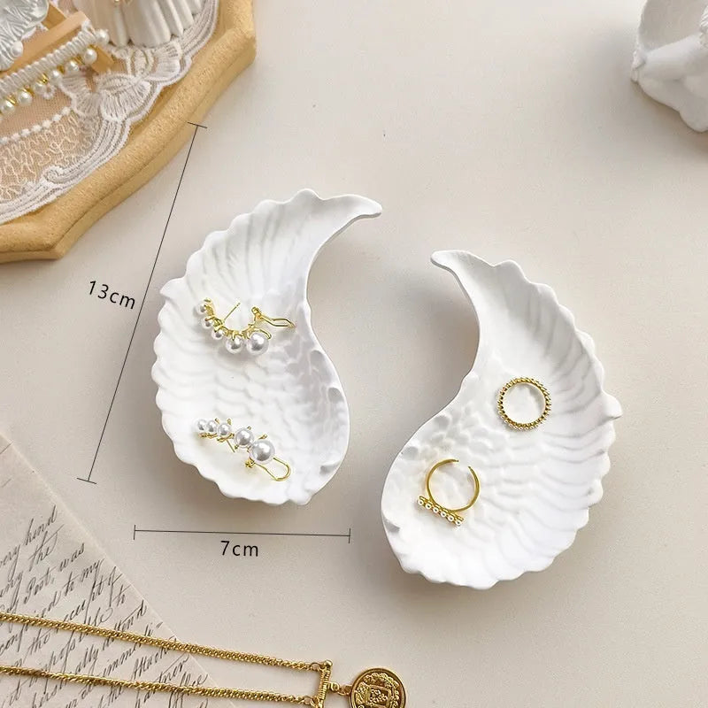 European Baroque style gypsum jewellery display plate with rings and earrings on a dressing table