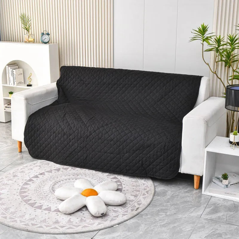 Reversible dog blanket sofa cover in grey and cream colours laid flat on a sofa