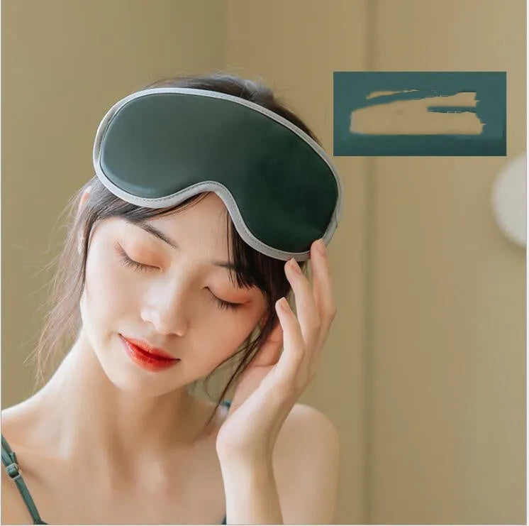 Pink and green portable USB steam sleep massage goggles on a table