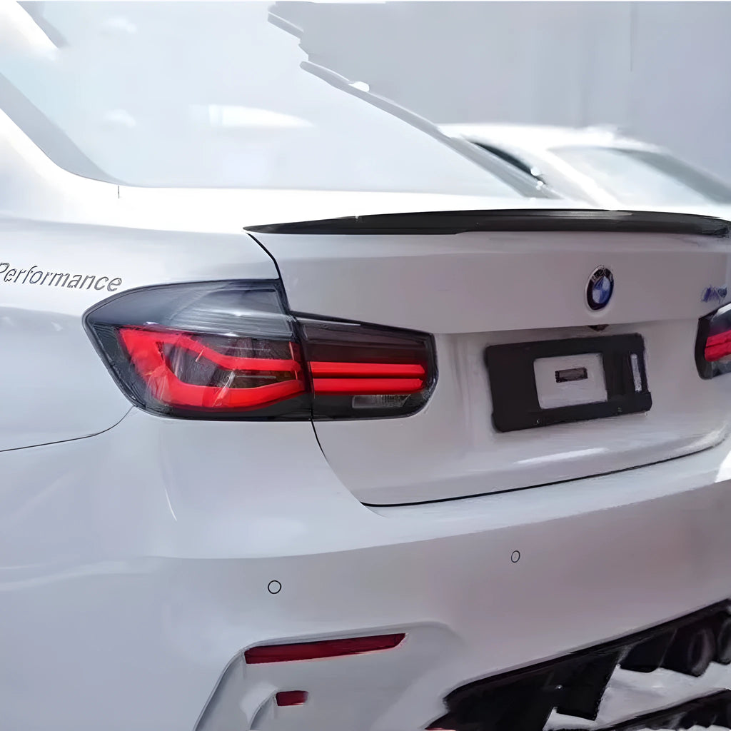 BMW 3 Series tail light assembly with LED streamer running light in smoked black or red finish.