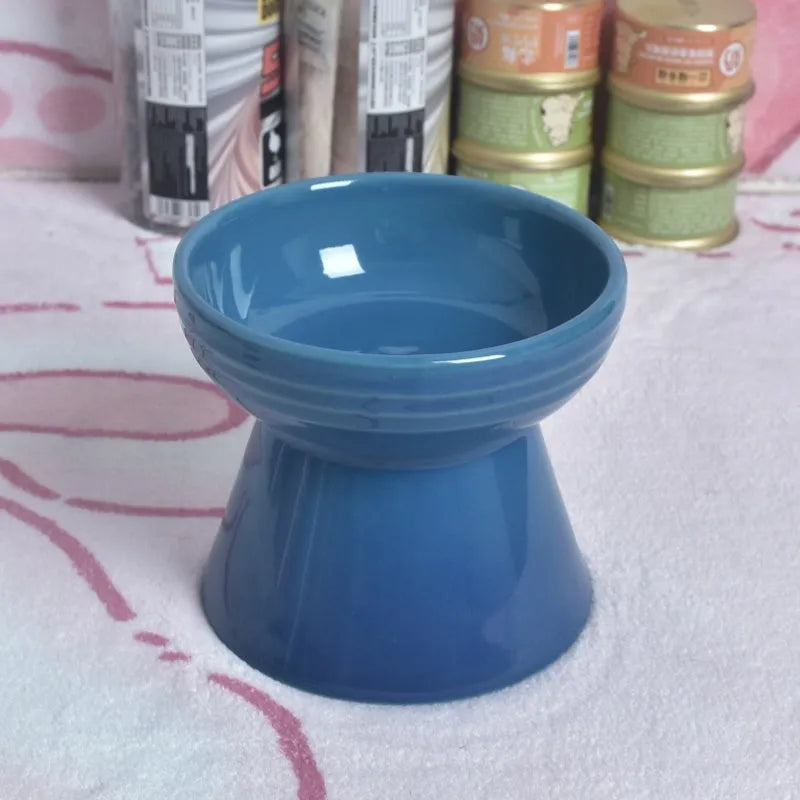 Black chin-high foot ceramic pet bowl for dogs and cats on a flat surface.