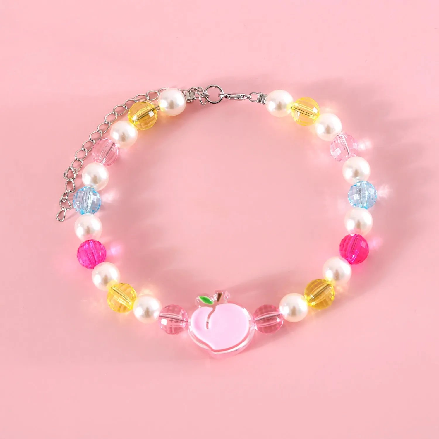 Colourful plastic bead cat necklace in rainbow, peach, or small flower pattern on a white background.