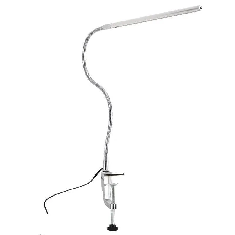 Silver aluminium alloy LED clip-on table lamp with long adjustable arm for nail art lighting.