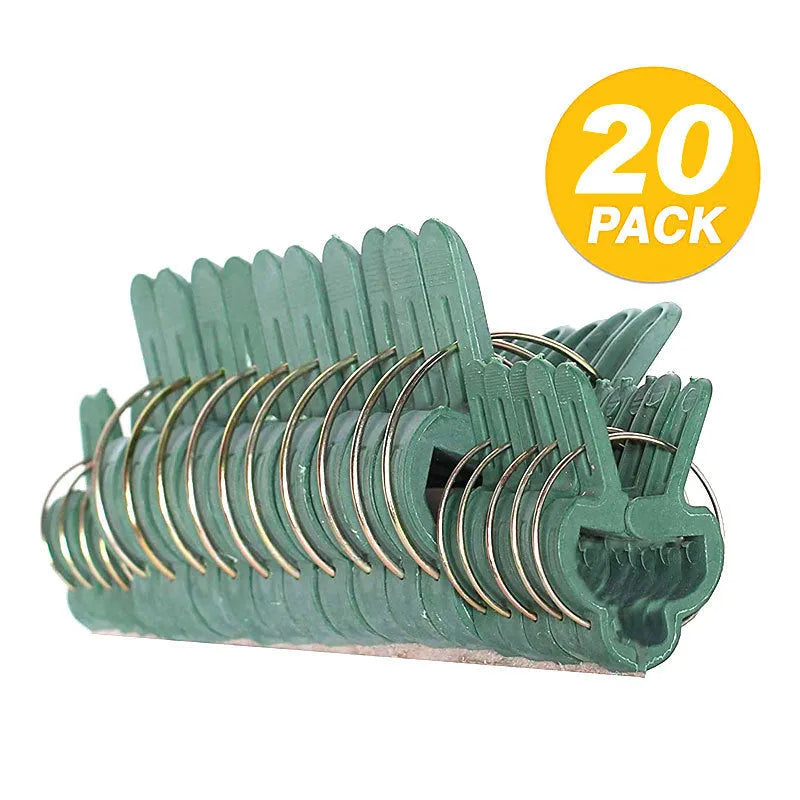 Green plastic and zinc plant fixing clips for supporting tomato vines and climbing plants in the garden.