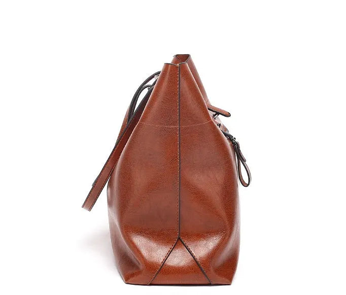 Brown waxed cowhide leather cross-body handbag showing two main compartments and a front mobile phone pocket.