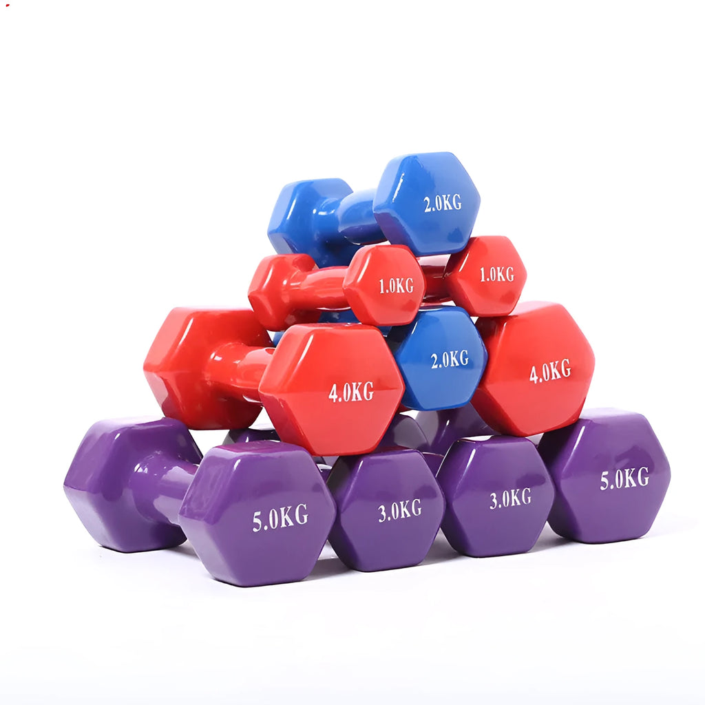 Set of bright colour plastic fitness dumbbells in various weights on a floor.