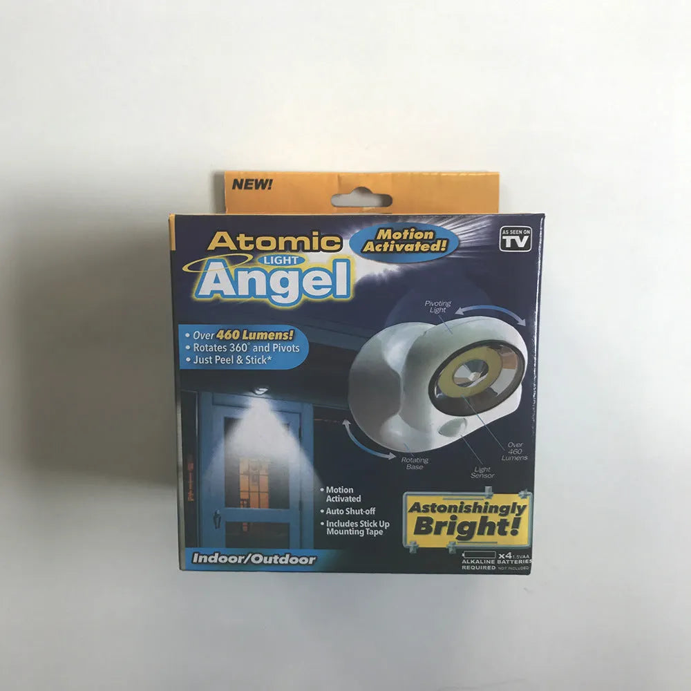 White Atomic Angel induction light lamp on a surface showing its compact size.
