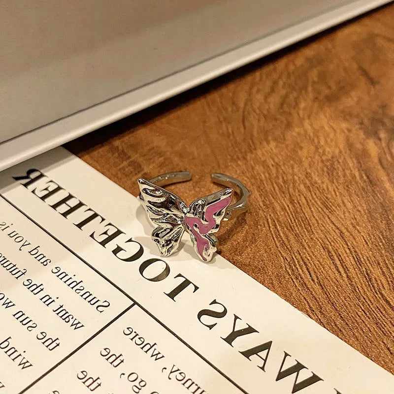 Copper butterfly women's ring with oil-drip finish showing open-loop design