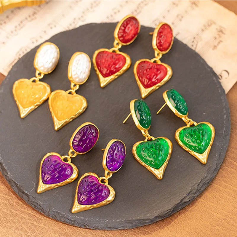 Silver textured oval love heart stud earrings in purple, red, green, and yellow white on a jewellery card.