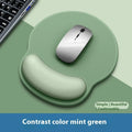 Silicone mouse mat with wristband in mint green colour on a desk