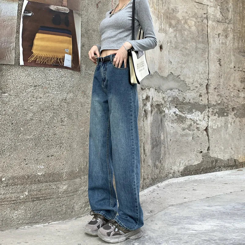 Women's retro blue high-waist straight-leg jeans on a neutral background.