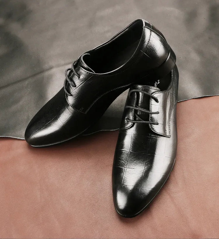 Men's black handcrafted leather derby shoes with a pointed toe and rubber sole.