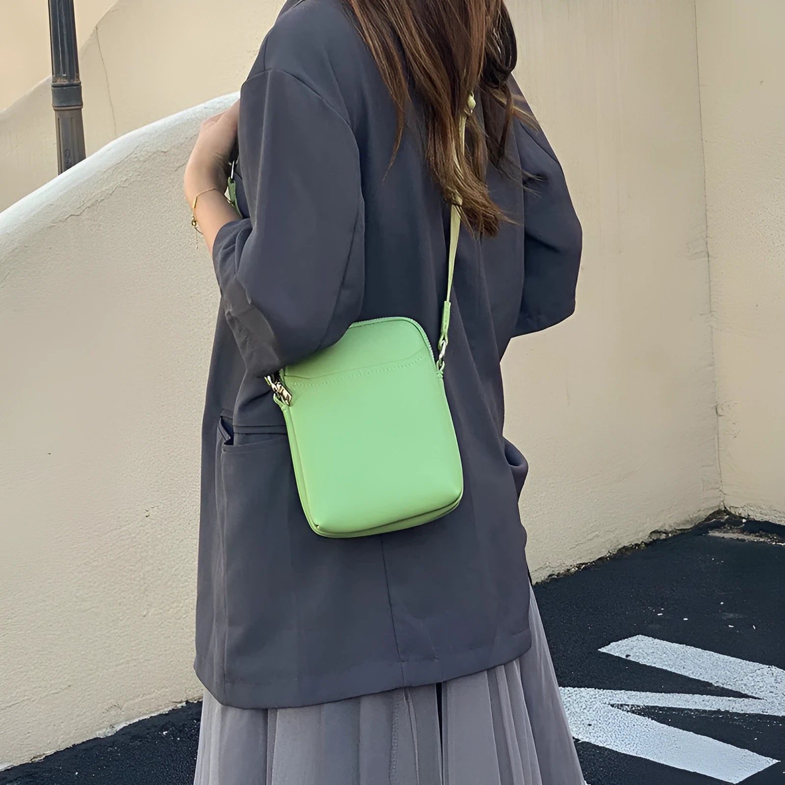Small solid colour PU leather crossbody bag for women in black, shown with shoulder strap.