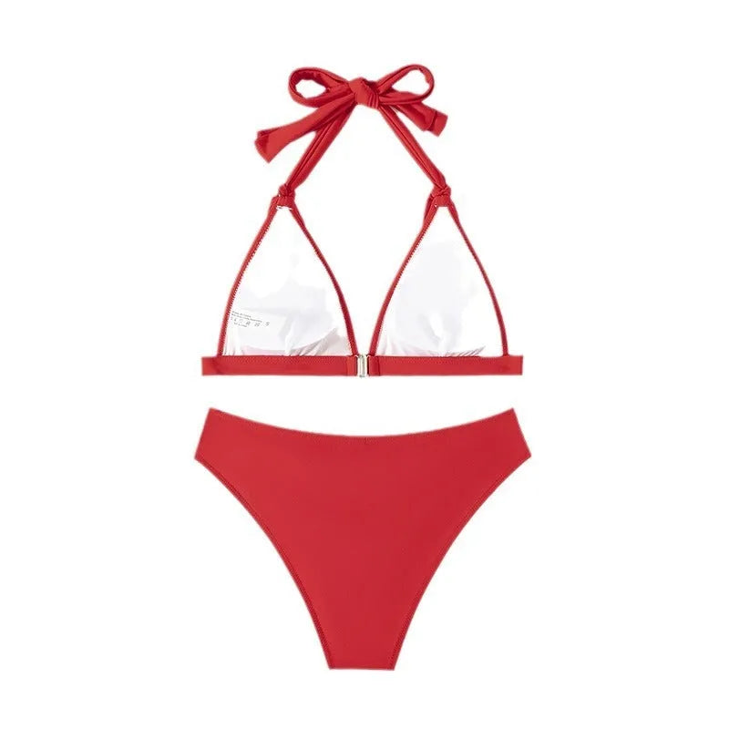 Red women's lace-up halterneck bikini with split shorts on a mannequin.