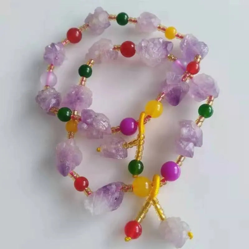A women's bracelet made of purple natural amethyst beads with a fu character charm.