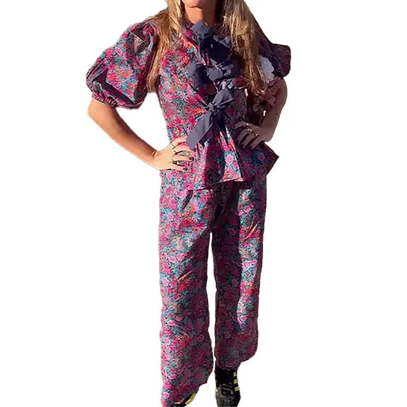 Women's floral print trouser suit set with tie-neck blouse and puff sleeves