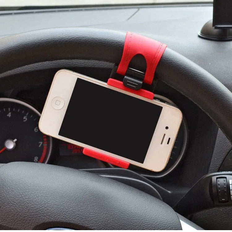 Black universal steering wheel phone holder clip mounted on a car steering wheel with a smartphone secured.