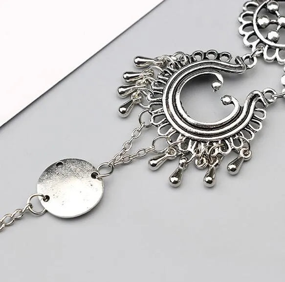 Antique silver hollow flower chain anklet with teardrop shape on a surface, 24cm foot jewellery for women