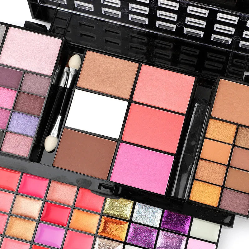 74 colour makeup palette with four layers showing eyeshadows, lip glosses, blush and contour powders with brush set