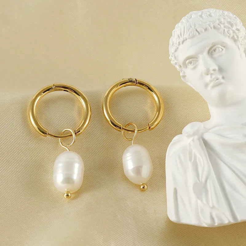 Gold geometric stainless steel earrings with pearl decorative elements and titanium posts