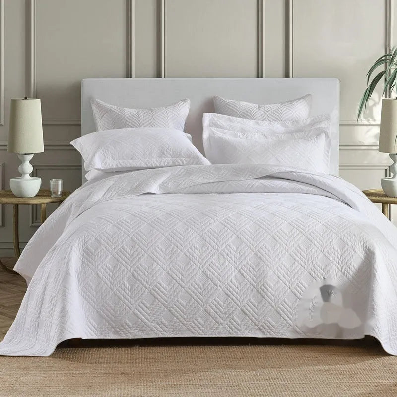 Pure cotton double-sided bed cover three-piece set in a plain colour laid on a bed.