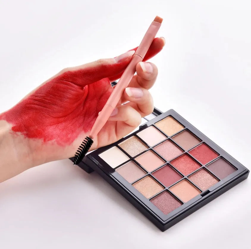 Ten professional makeup brushes with wooden handles arranged by size for different cosmetic applications