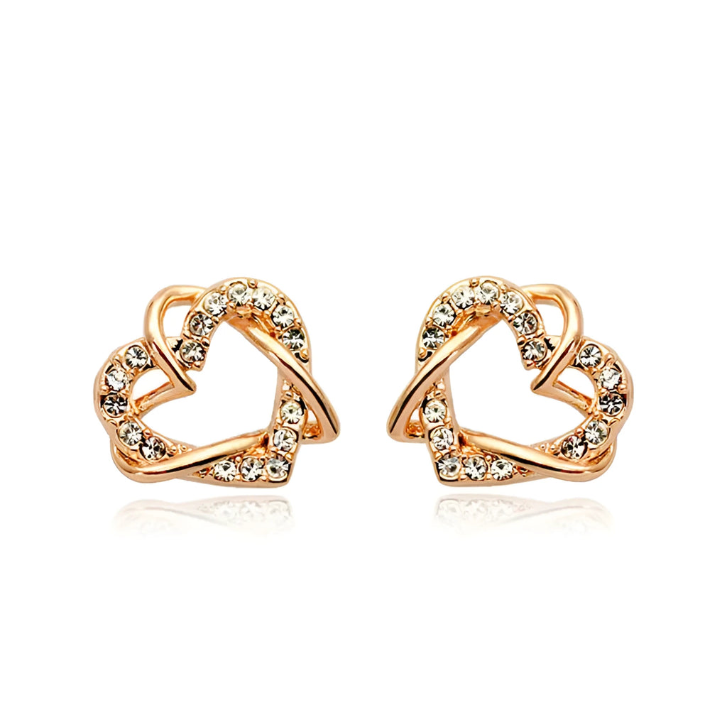 Gold colour alloy heart-shaped stud earrings on white background