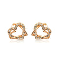 Gold colour alloy heart-shaped stud earrings on white background