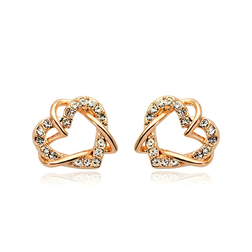 Gold colour alloy heart-shaped stud earrings on white background