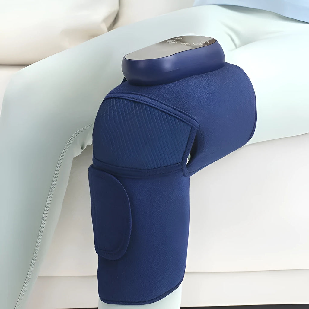 Blue self-heating knee massager unit with adjustable strap for vibration and air pressure therapy.