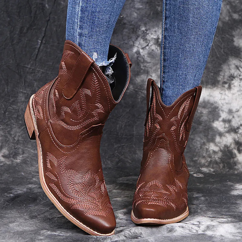 Blue women's cowboy boots with embroidery on the shaft and a low wedge heel.