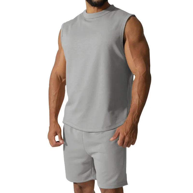 Men's sleeveless cotton blend sports suit showing sleeveless top and matching shorts in a solid colour.