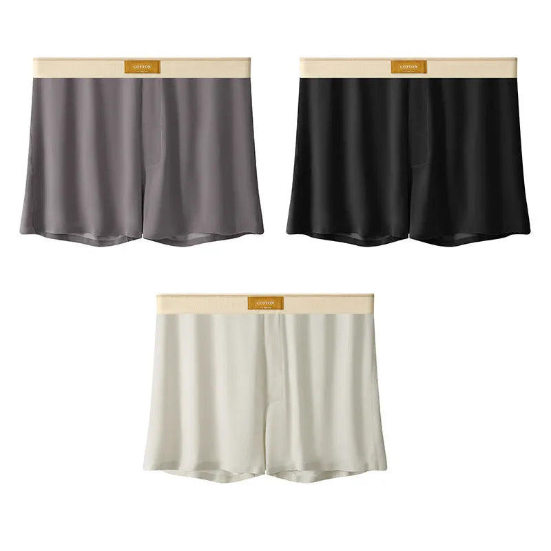 Men's solid colour loose ice silk underwear in a pack of three, shown in beige, black, and grey.