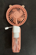 USB handheld personal fan in apricot colour with plastic nozzle, shown with charging cable.