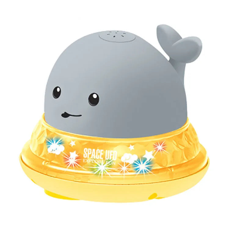 Blue and white whale bath toy with water spray and flashing lights for baby sensory play