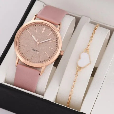 Women's pink quartz watch set with faux leather strap and bracelet on a light background