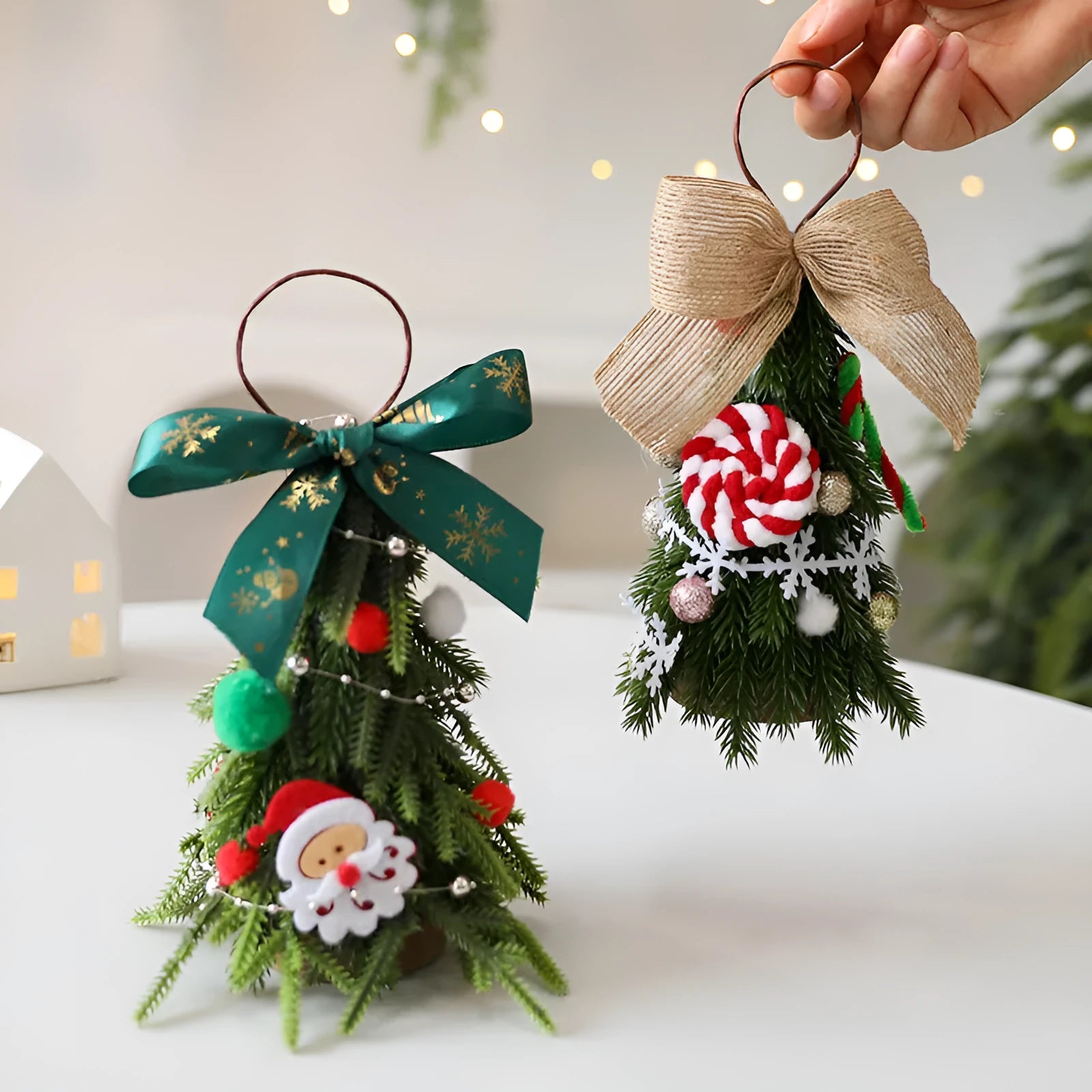 Mini Christmas tree ornament in red and white snowflake design on a tree branch