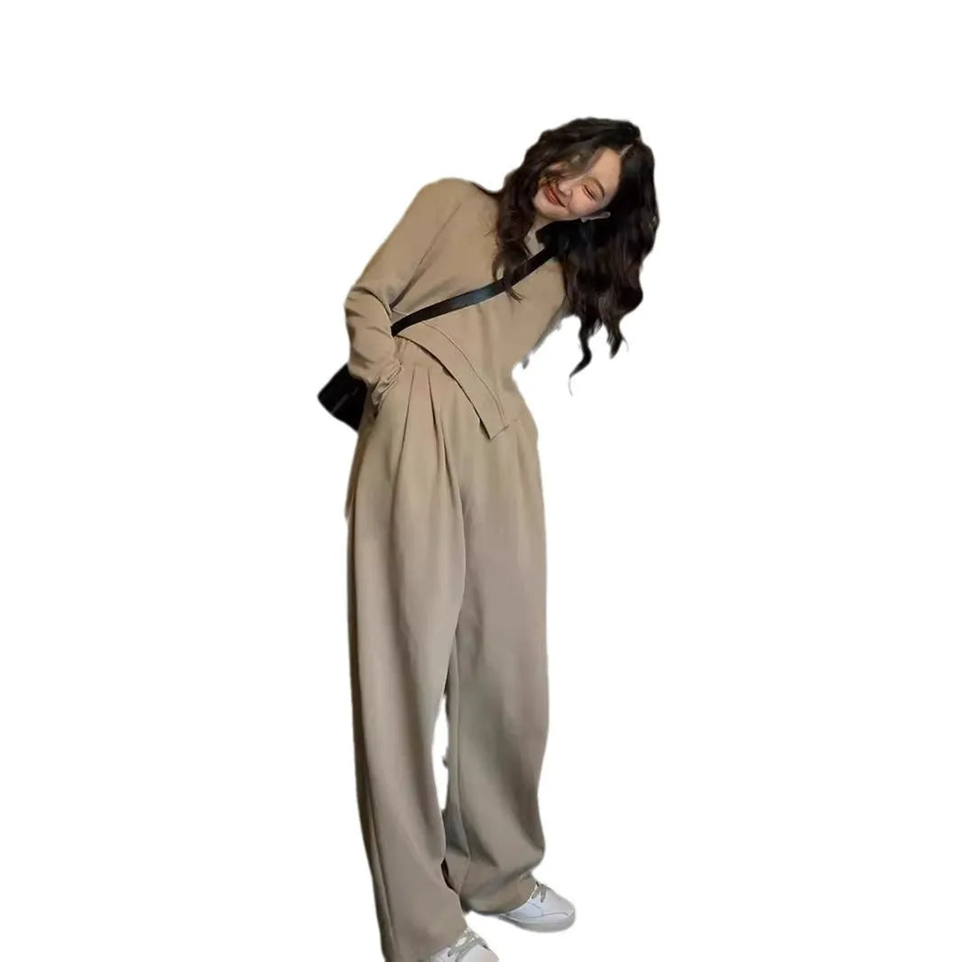 Women's khaki loose-fit casual sports suit with long sleeve top and trousers on a hanger.