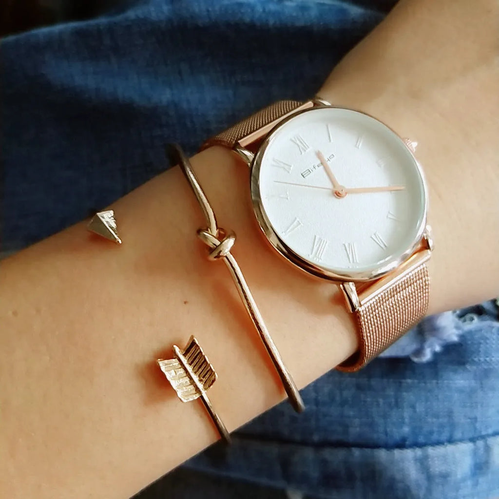 Gold vintage women's cuff bracelet with arrow and knotted design details.