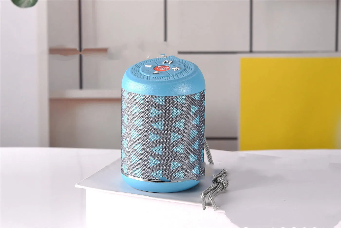 Portable outdoor Bluetooth subwoofer in multiple colours showing button controls for radio and playback functions.