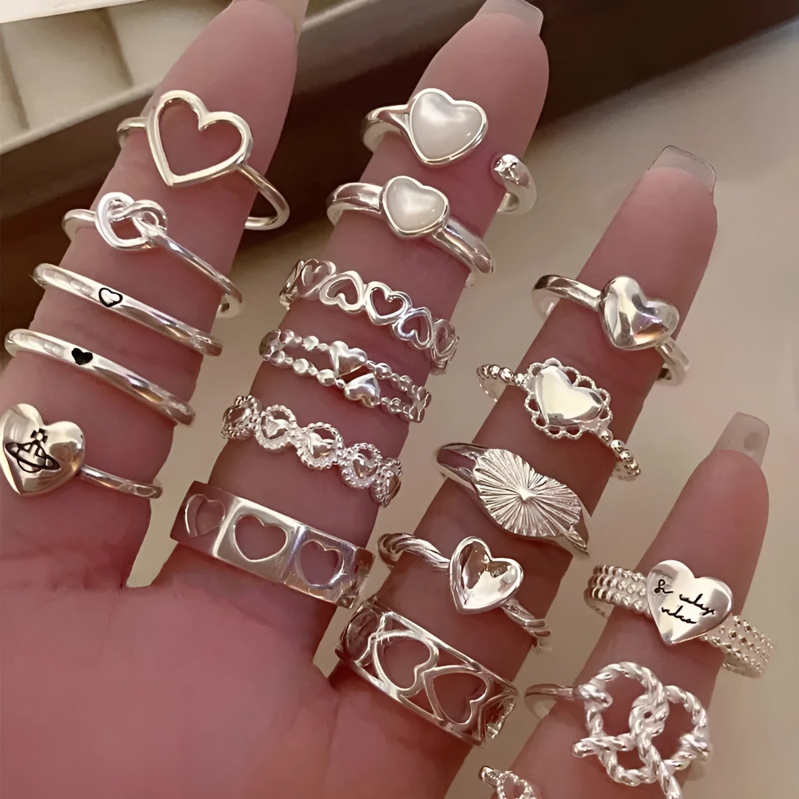 Adjustable copper love heart-shaped ring with electroplated finish on white background