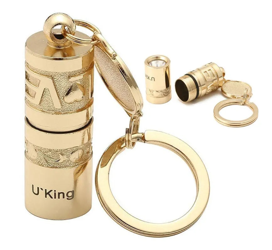 Gold zinc alloy waterproof mini LED flashlight on a keychain ring.