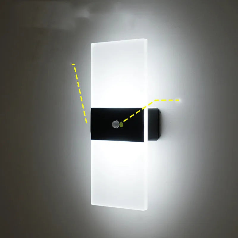 Magnetic rechargeable wall lamp in arc style, black finish, with warm light on a metal bedside shelf