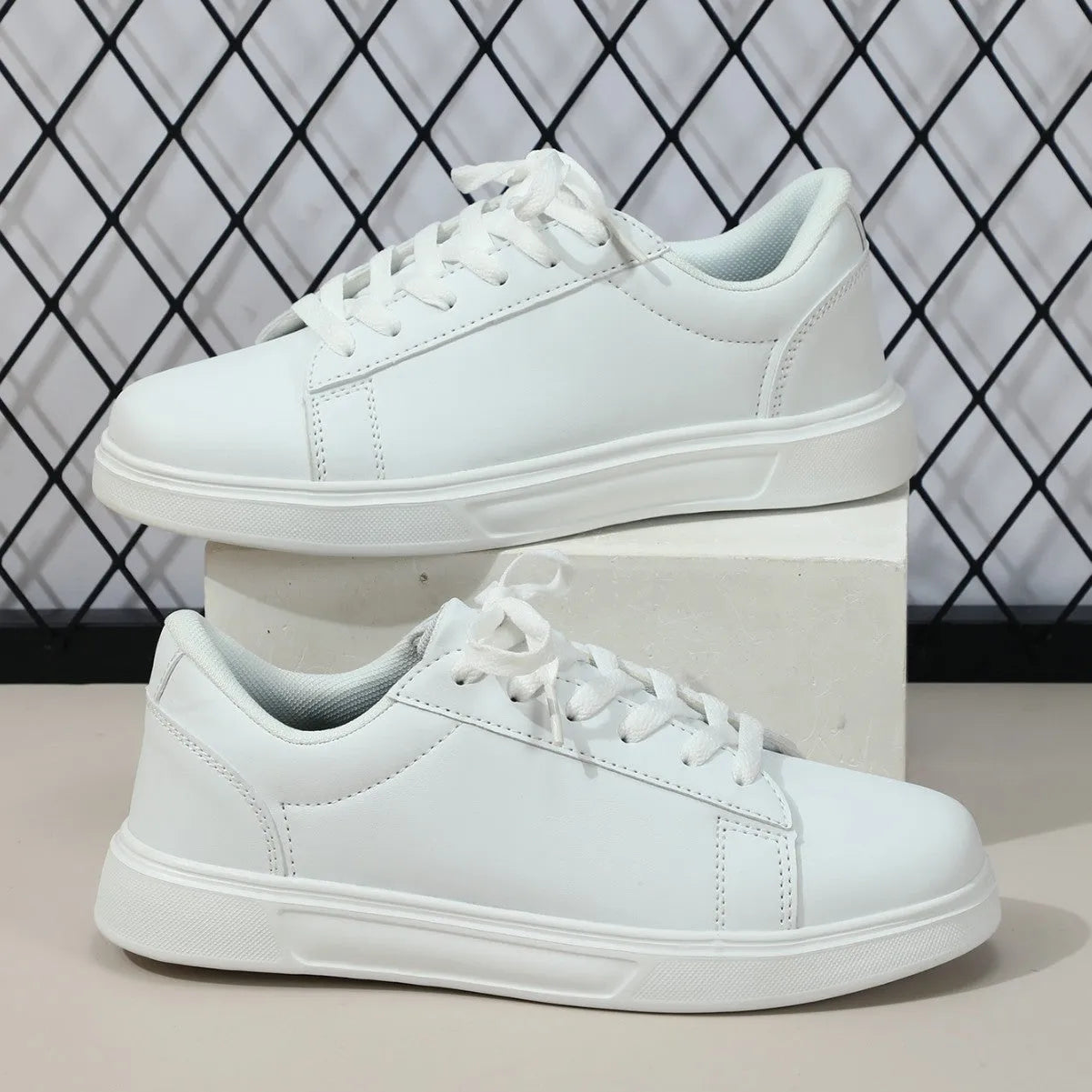 Casual beige brown platform sneakers with a cross strap and round toe on a flat rubber sole.