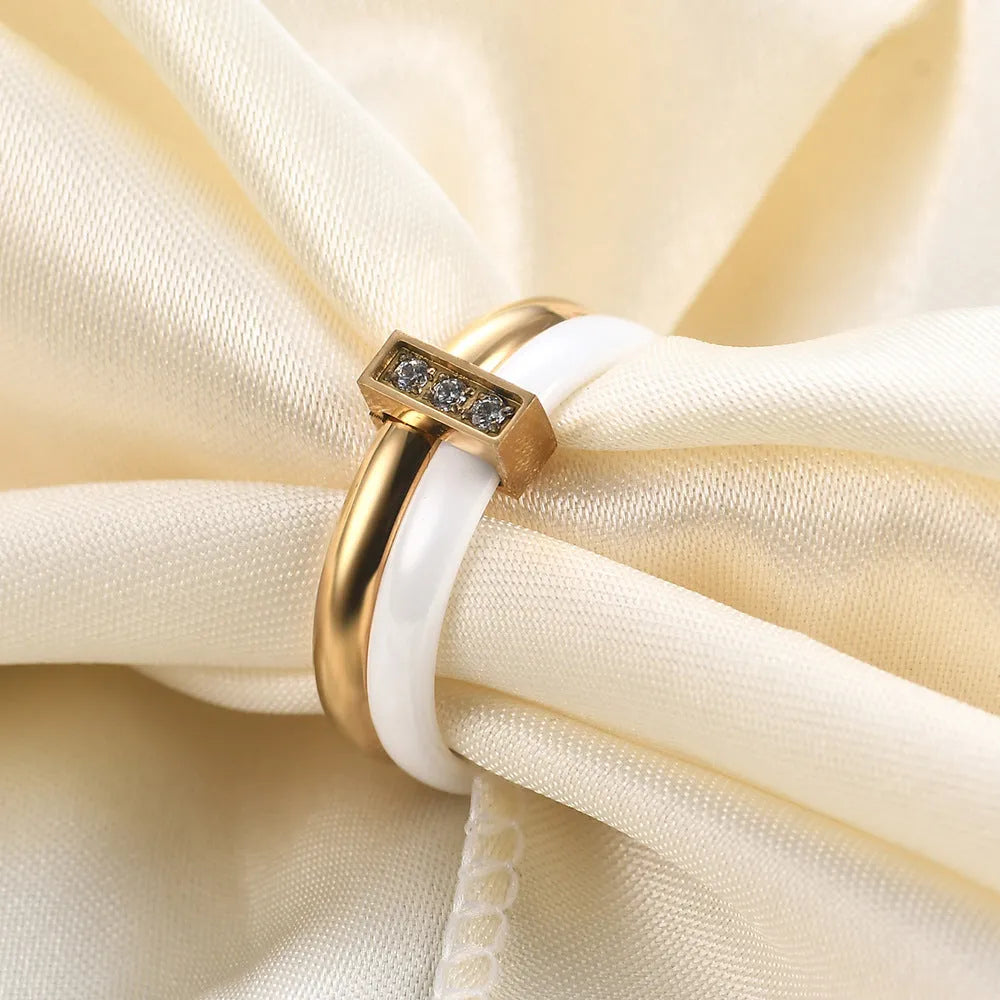 Steel black ceramic women's ring with glossy stitching and zirconium accents, geometric shape.